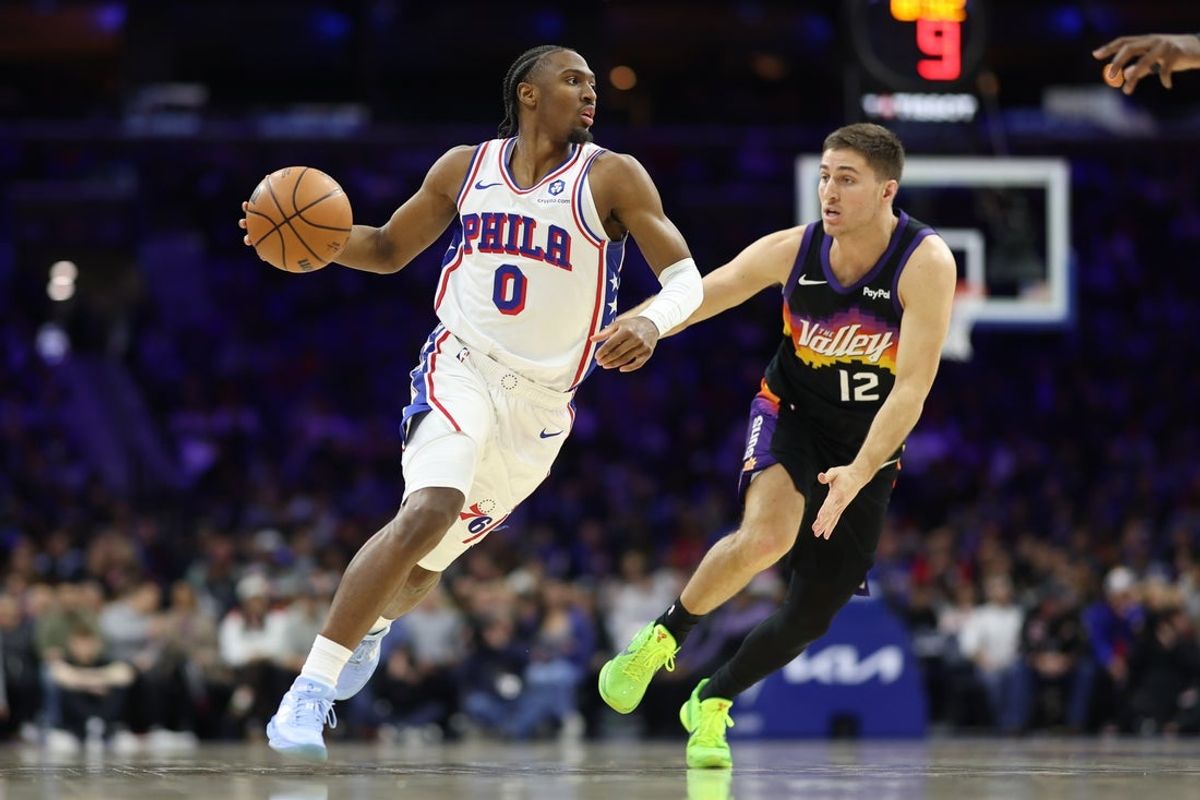 Jan 20, 2026; Philadelphia, Pennsylvania, USA; Philadelphia 76ers guard Tyrese Maxey (0) drives against Phoenix Suns guard Collin Gillespie (12) during the third quarter at Xfinity Mobile Arena. Mandatory Credit: Bill Streicher-Imagn Images