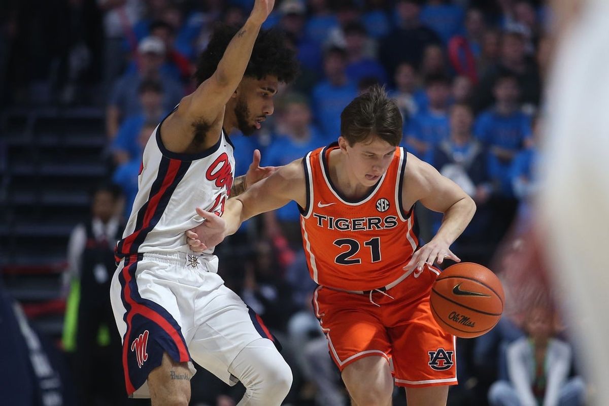 Jan 20, 2026; Oxford, Mississippi, USA; Auburn Tigers guard Blake Muschalek (21) dribbles as Mississippi Rebels guard Kezza Giffa (13) defends during the first half at The Sandy and John Black Pavilion at Ole Miss. Mandatory Credit: Petre Thomas-Imagn Images