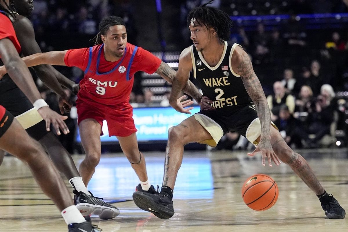 Jan 20, 2026; Winston-Salem, North Carolina, USA;  Wake Forest Demon Deacons forward Juke Harris (2) handles the ball against Southern Methodist University Mustangs forward B.J. Davis-Ray (9) during the first half at Lawrence Joel Veterans Memorial Coliseum. Mandatory Credit: Jim Dedmon-Imagn Images