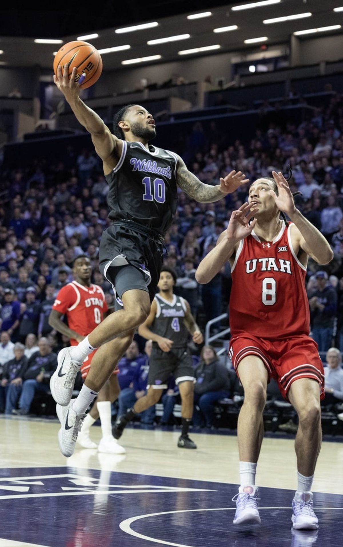 Jan 20, 2026; Manhattan, Kansas, USA; Kansas State Wildcats guard David Castillo (10) goes to the basket against Utah Utes forward Keanu Dawes (8) during the first half at Bramlage Coliseum. Mandatory Credit: Scott Sewell-Imagn Images