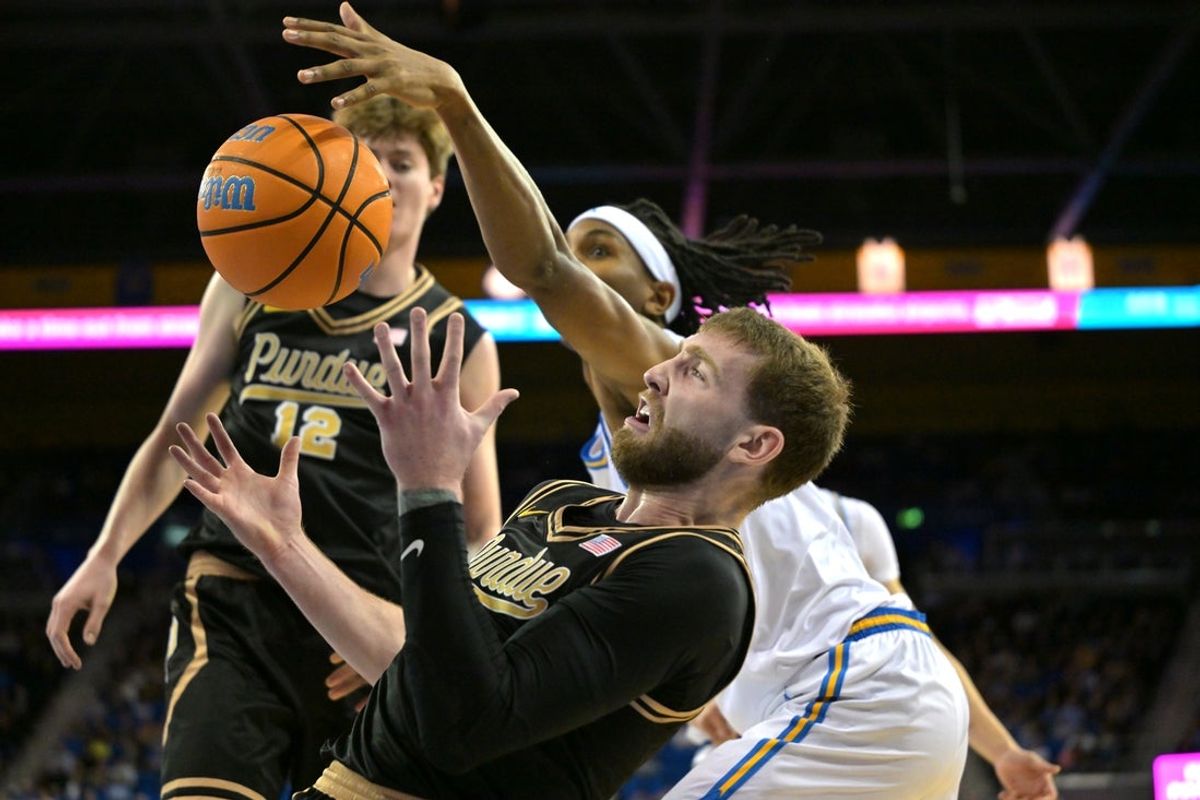 Jan 20, 2026; Los Angeles, California, USA;  UCLA Bruins forward Steven Jamerson II (24) and Purdue Boilermakers guard Braden Smith (3) battle for a rebond  in the first half at Pauley Pavilion presented by Wescom Financial. Mandatory Credit: Jayne Kamin-Oncea-Imagn Images