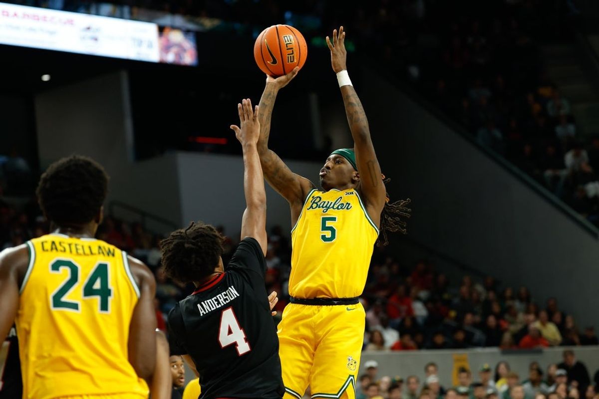 Jan 20, 2026; Waco, Texas, USA;  Baylor Bears guard Obi Agbim (5) scores a basket over Texas Tech Red Raiders guard Christian Anderson (4) during the second half at Paul and Alejandra Foster Pavilion. Mandatory Credit: Chris Jones-Imagn Images