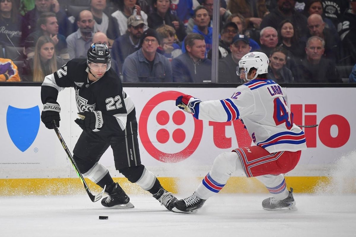 Jan 20, 2026; Los Angeles, California, USA; Los Angeles Kings left wing Kevin Fiala (22) moves the puck against New York Rangers center Noah Laba (42) during the first period at Crypto.com Arena. Mandatory Credit: Gary A. Vasquez-Imagn Images