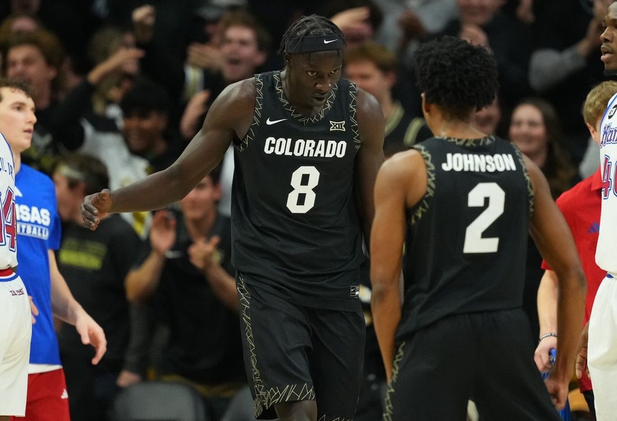 Jan 20, 2026; Boulder, Colorado, USA; Colorado Buffaloes forward Bangot Dak (8) reacts after a score with guard Isaiah Johnson (2) in the first half against the Kansas Jayhawks at the CU Events Center. Mandatory Credit: Ron Chenoy-Imagn Images