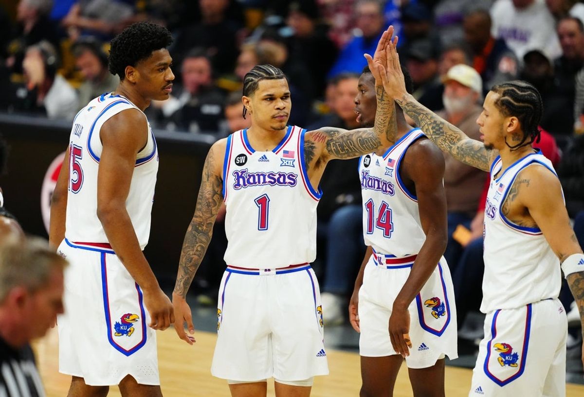 Jan 20, 2026; Boulder, Colorado, USA; Kansas Jayhawks guard Tre White (3),guard Melvin Council Jr. (14),Kansas Jayhawks guard Jayden Dawson (1) and forward Bryson Tiller (15) react in the first half against the Colorado Buffaloes at the CU Events Center. Mandatory Credit: Ron Chenoy-Imagn Images