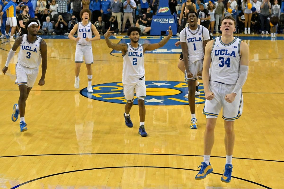 Jan 20, 2026; Los Angeles, California, USA; UCLA Bruins guard Eric Dailey Jr. (3), guard Trent Perry (0), guard Donovan Dent (2) and forward Xavier Booker (1) celebrate after a 3-point basket by forward Tyler Bilodeau (34) in the final seconds of the game against the Purdue Boilermakers in the second half at Pauley Pavilion presented by Wescom Financial. Mandatory Credit: Jayne Kamin-Oncea-Imagn Images