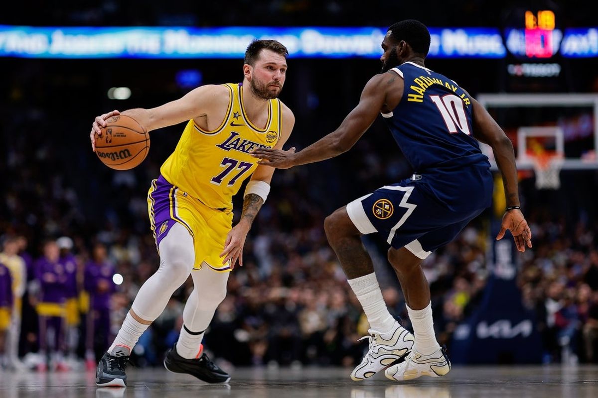 Jan 20, 2026; Denver, Colorado, USA; Los Angeles Lakers guard Luka Doncic (77) controls the ball as Denver Nuggets guard Tim Hardaway Jr. (10) guards in the fourth quarter at Ball Arena. Mandatory Credit: Isaiah J. Downing-Imagn Images