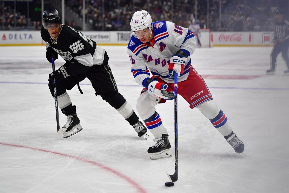 Jan 20, 2026; Los Angeles, California, USA; New York Rangers left wing Artemi Panarin (10) moves the puck against Los Angeles Kings right wing Quinton Byfield (55) during the third period at Crypto.com Arena. Mandatory Credit: Gary A. Vasquez-Imagn Images