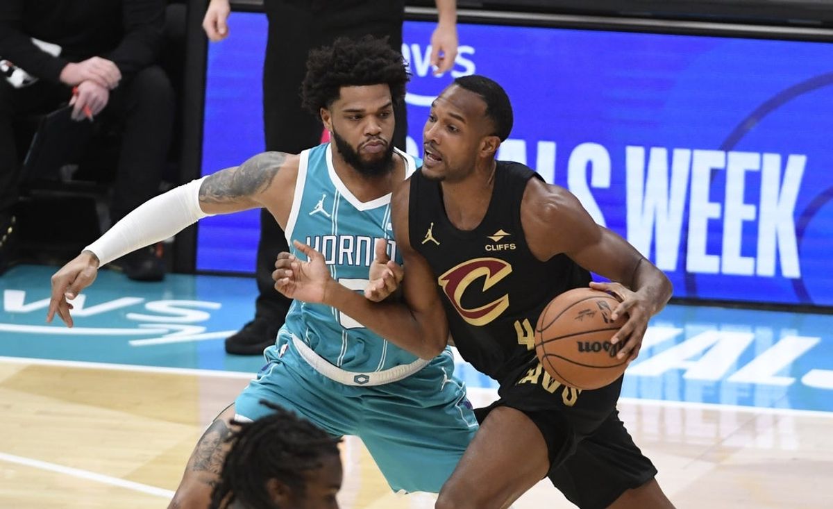 Jan 21, 2026; Charlotte, North Carolina, USA;  Cleveland Cavaliers forward center Evan Mobley (4) drives past Charlotte Hornets forward Miles Bridges (0) during the first half at the Spectrum Center. Mandatory Credit: Sam Sharpe-Imagn Images