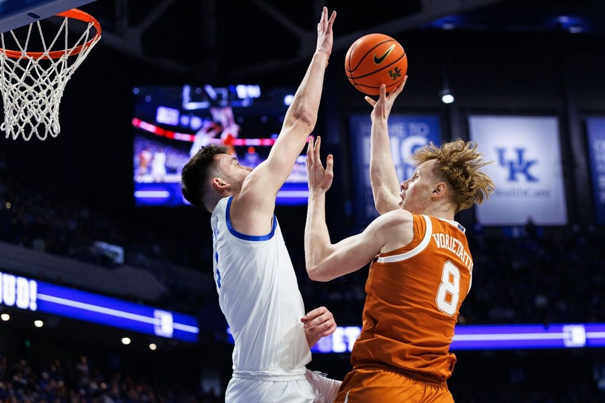 Jan 21, 2026; Lexington, Kentucky, USA; Texas Longhorns center Matas Vokietaitis (8) goes to the basket against Kentucky Wildcats forward Andrija Jelavic (4) during the first half at Rupp Arena at Central Bank Center. Mandatory Credit: Jordan Prather-Imagn Images