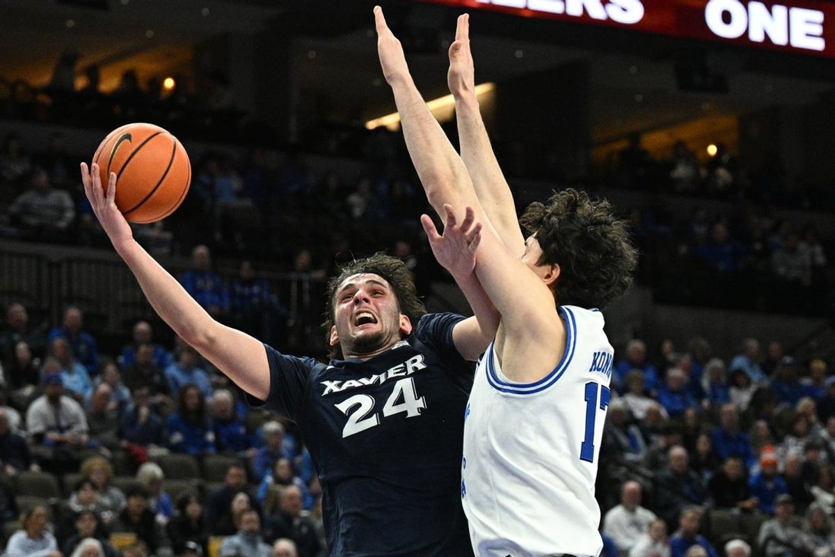 Jan 21, 2026; Omaha, Nebraska, USA;  Xavier Musketeers forward Jovan Milicevic (24) attempts a shot against Creighton Bluejays forward Kerem Konan (17) during the first half at CHI Health Center Omaha. Mandatory Credit: Steven Branscombe-Imagn Images