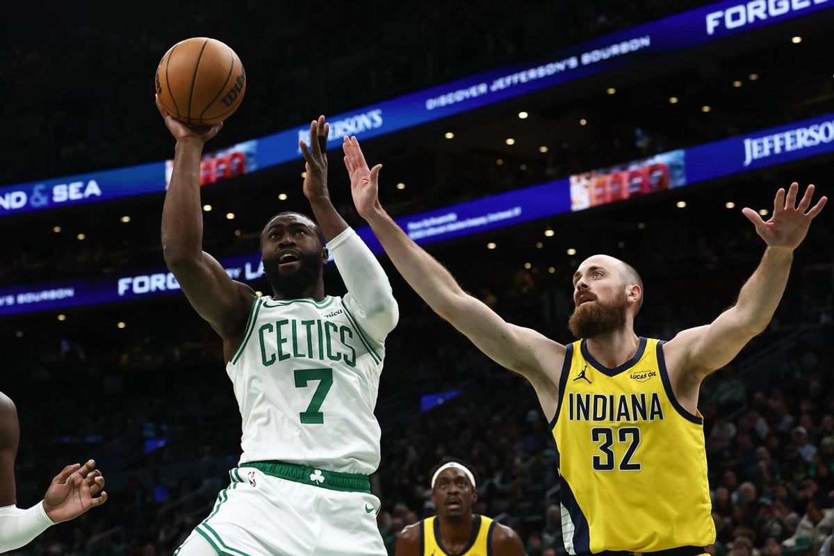 Jan 21, 2026; Boston, Massachusetts, USA; Boston Celtics guard Jaylen Brown (7) goes past Indiana Pacers center Jay Huff (32) during the first quarter at TD Garden. Mandatory Credit: Winslow Townson-Imagn Images