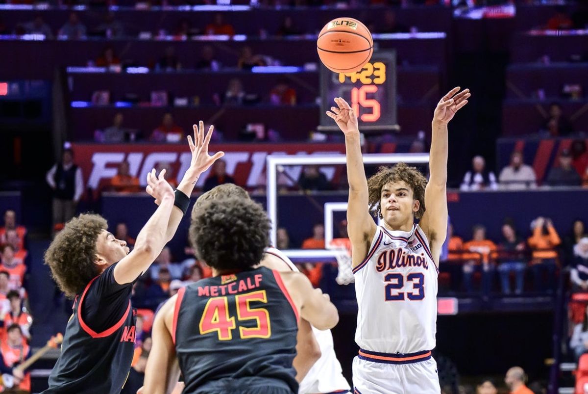 Jan 21, 2026; Champaign, Illinois, USA; Illinois Fighting Illini guard Keaton Wagler (23) shoots against Maryland Terrapins center Collin Metcalf (45) in the first half at State Farm Center. Mandatory Credit: Fred Zwicky-Imagn Images