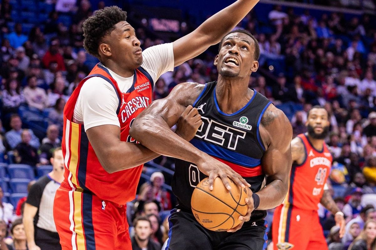 Jan 21, 2026; New Orleans, Louisiana, USA;  New Orleans Pelicans center Derik Queen (22) fouls Detroit Pistons center Jalen Duren (0) during the first half at Smoothie King Center. Mandatory Credit: Stephen Lew-Imagn Images