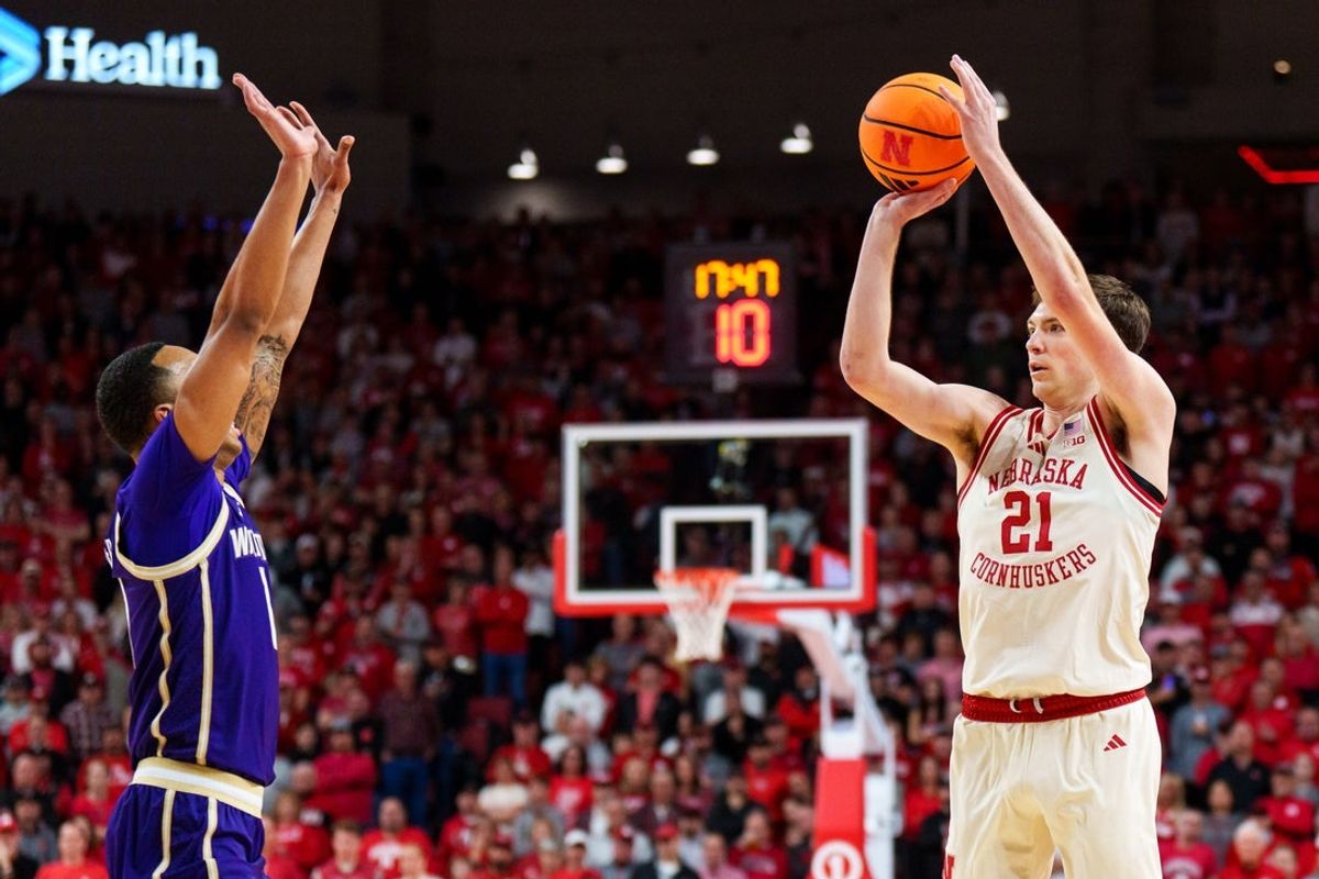 Jan 21, 2026; Lincoln, Nebraska, USA; Nebraska Cornhuskers forward Pryce Sandfort (21) shoots a three-point basket against Washington Huskies forward Bryson Tucker (8) during the first half at Pinnacle Bank Arena. Mandatory Credit: Dylan Widger-Imagn Images