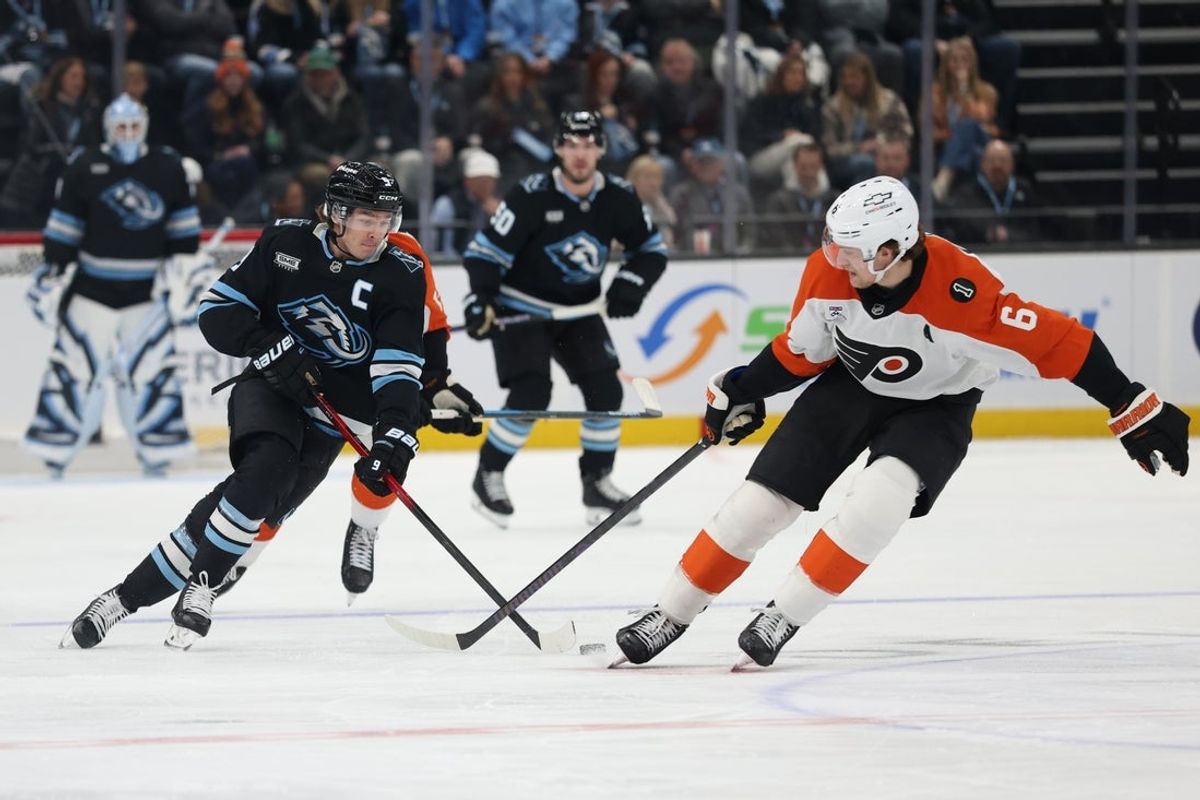 Jan 21, 2026; Salt Lake City, Utah, USA; Utah Mammoth right wing Clayton Keller (9) advances the puck against Philadelphia Flyers defenseman Travis Sanheim (6) during the first period at Delta Center. Mandatory Credit: Rob Gray-Imagn Images
