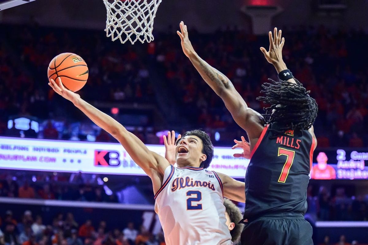 Jan 21, 2026; Champaign, Illinois, USA; Illinois Fighting Illini guard Andrej Stojakovic (2) drives for a basket against Maryland Terrapins guard Andre Mills (7) during the second half at State Farm Center. Mandatory Credit: Fred Zwicky-Imagn Images