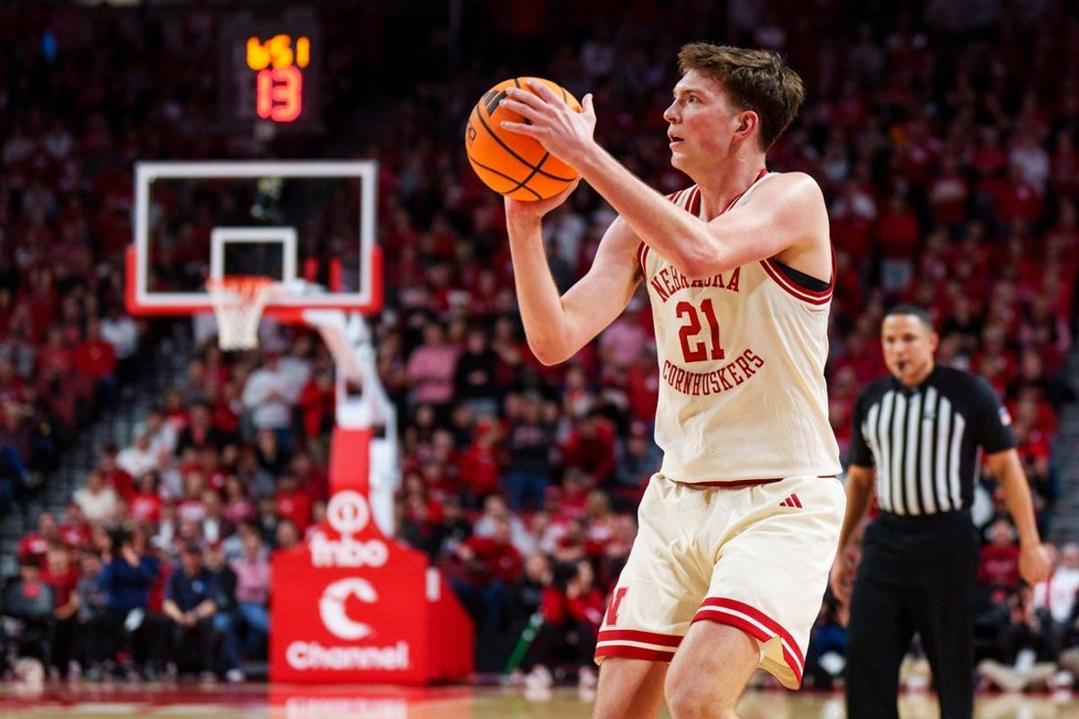 Jan 21, 2026; Lincoln, Nebraska, USA; Nebraska Cornhuskers forward Pryce Sandfort (21) shoots a three-point basket against the Washington Huskies during the first half at Pinnacle Bank Arena. Mandatory Credit: Dylan Widger-Imagn Images