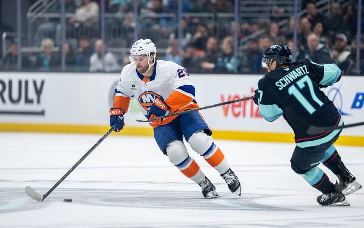 Jan 21, 2026; Seattle, Washington, USA; New York Islanders forward Jonathan Drouin (29) skates against Seattle Kraken forward Jaden Schwartz (17) during the first period at Climate Pledge Arena. Mandatory Credit: Stephen Brashear-Imagn Images