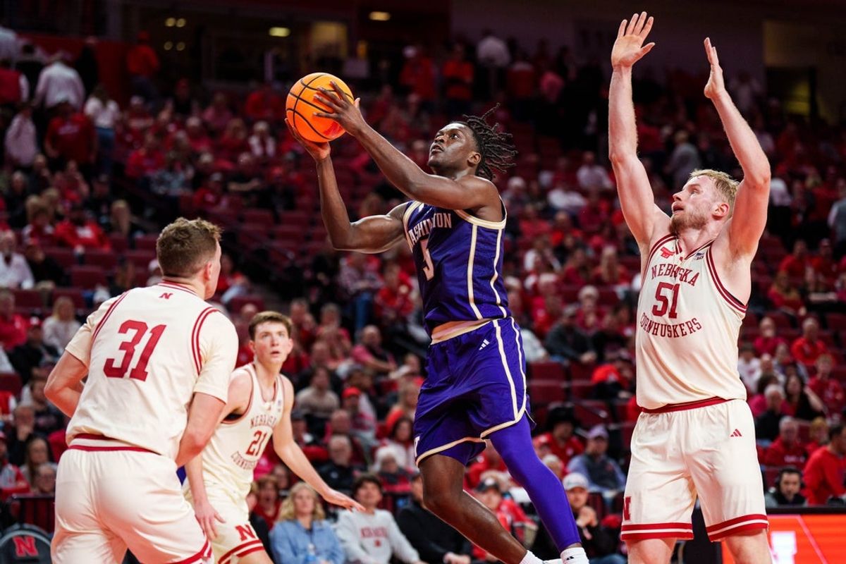Jan 21, 2026; Lincoln, Nebraska, USA; Washington Huskies guard Zoom Diallo (5) shoots the ball against Nebraska Cornhuskers guard Cale Jacobsen (31) and forward Rienk Mast (51) during the second half at Pinnacle Bank Arena. Mandatory Credit: Dylan Widger-Imagn Images