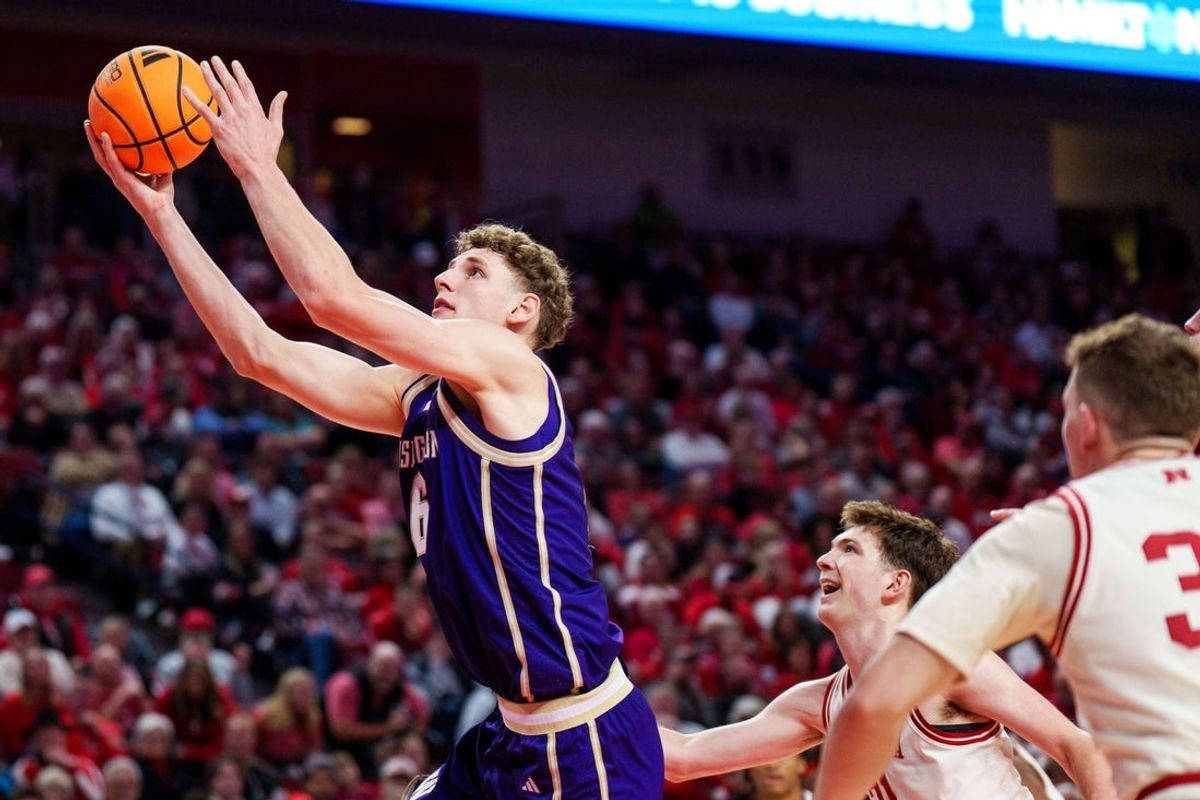 Jan 21, 2026; Lincoln, Nebraska, USA; Washington Huskies forward Hannes Steinbach (6) shoots the ball against Nebraska Cornhuskers forward Pryce Sandfort (21) and guard Cale Jacobsen (31) during the second half at Pinnacle Bank Arena. Mandatory Credit: Dylan Widger-Imagn Images