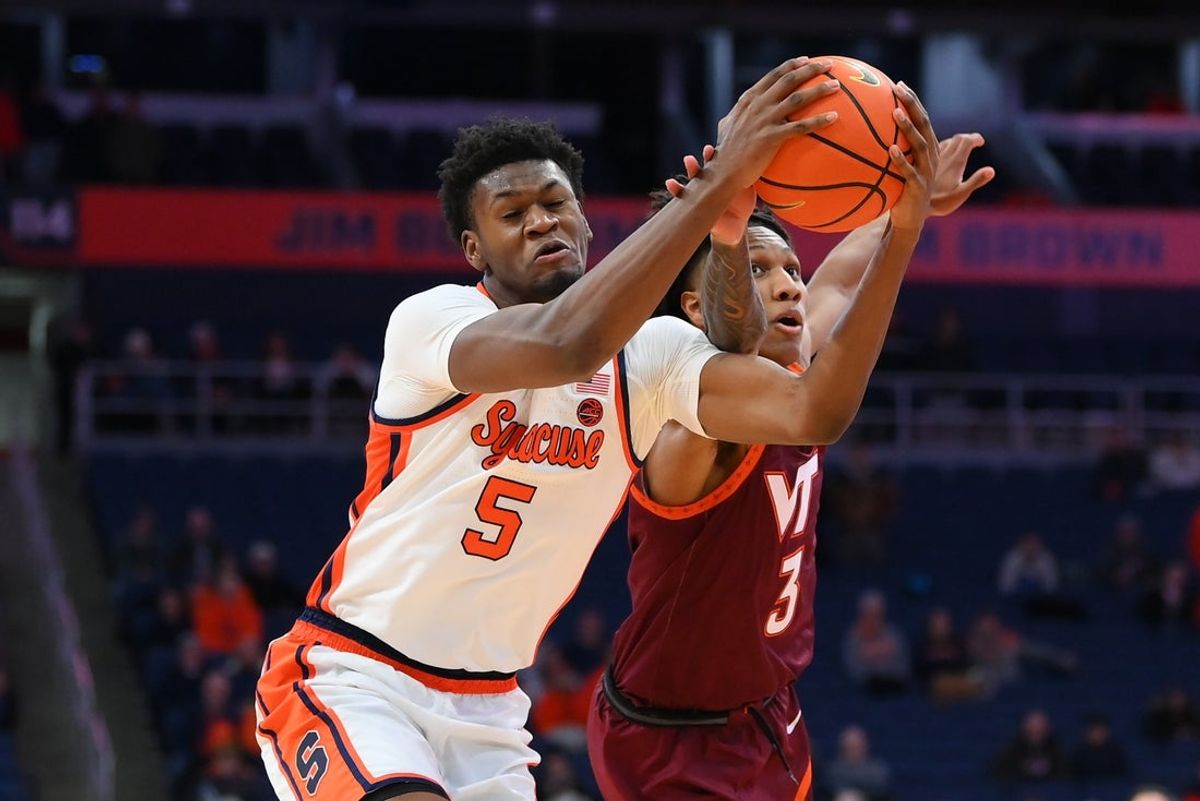 Jan 21, 2026; Syracuse, New York, USA; Syracuse Orange forward Tyler Betsey (5) and Virginia Tech Hokies guard Ben Hammond (3) battle for the ball during the second half at the JMA Wireless Dome. Mandatory Credit: Rich Barnes-Imagn Images