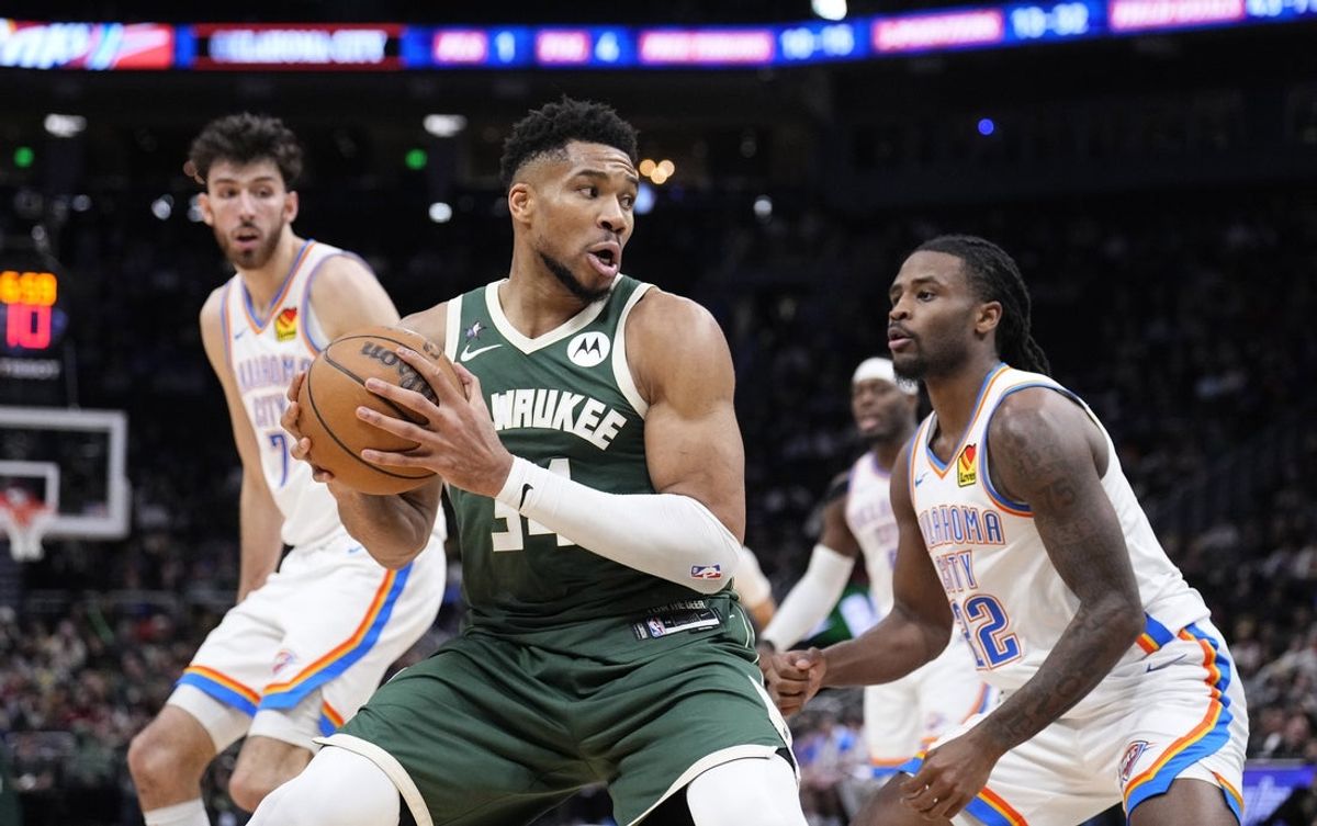 Jan 21, 2026; Milwaukee, Wisconsin, USA; Milwaukee Bucks forward Giannis Antetokounmpo (34) drives to the basket against Oklahoma City Thunder guard Cason Wallace (22) in the second half at Fiserv Forum. Mandatory Credit: Michael McLoone-Imagn Images