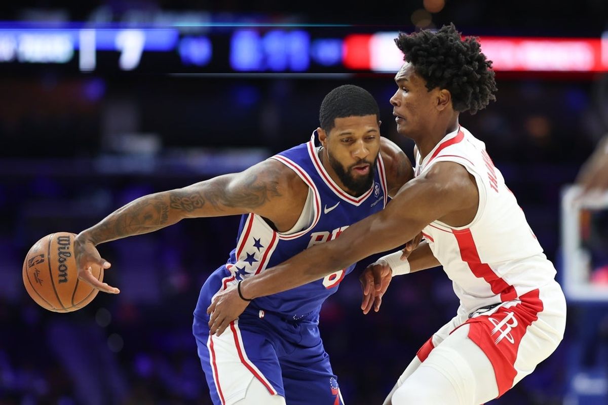 Jan 22, 2026; Philadelphia, Pennsylvania, USA; Houston Rockets guard Amen Thompson (1) knocks the ball away from Philadelphia 76ers forward Paul George (8) during the first quarter at Xfinity Mobile Arena. Mandatory Credit: Bill Streicher-Imagn Images