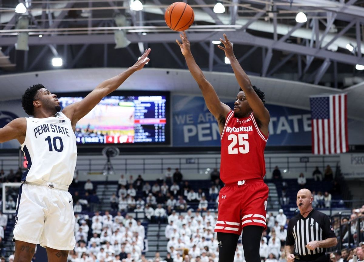 Jan 22, 2026; University Park, Pennsylvania, USA; Wisconsin Badgers guard John Blackwell (25) attempts a three-point shot as Penn State Nittany Lions forward Josh Reed (10) defends during the first half at Rec Hall. Mandatory Credit: Matthew O'Haren-Imagn Images