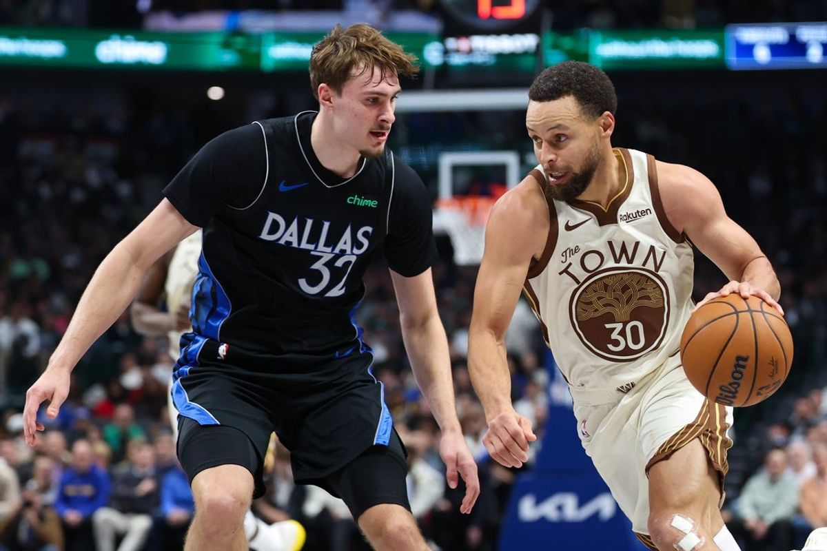 Jan 22, 2026; Dallas, Texas, USA; Golden State Warriors guard Stephen Curry (30) drives to the basket as Dallas Mavericks forward Cooper Flagg (32) defends  during the first half at American Airlines Center. Mandatory Credit: Kevin Jairaj-Imagn Images