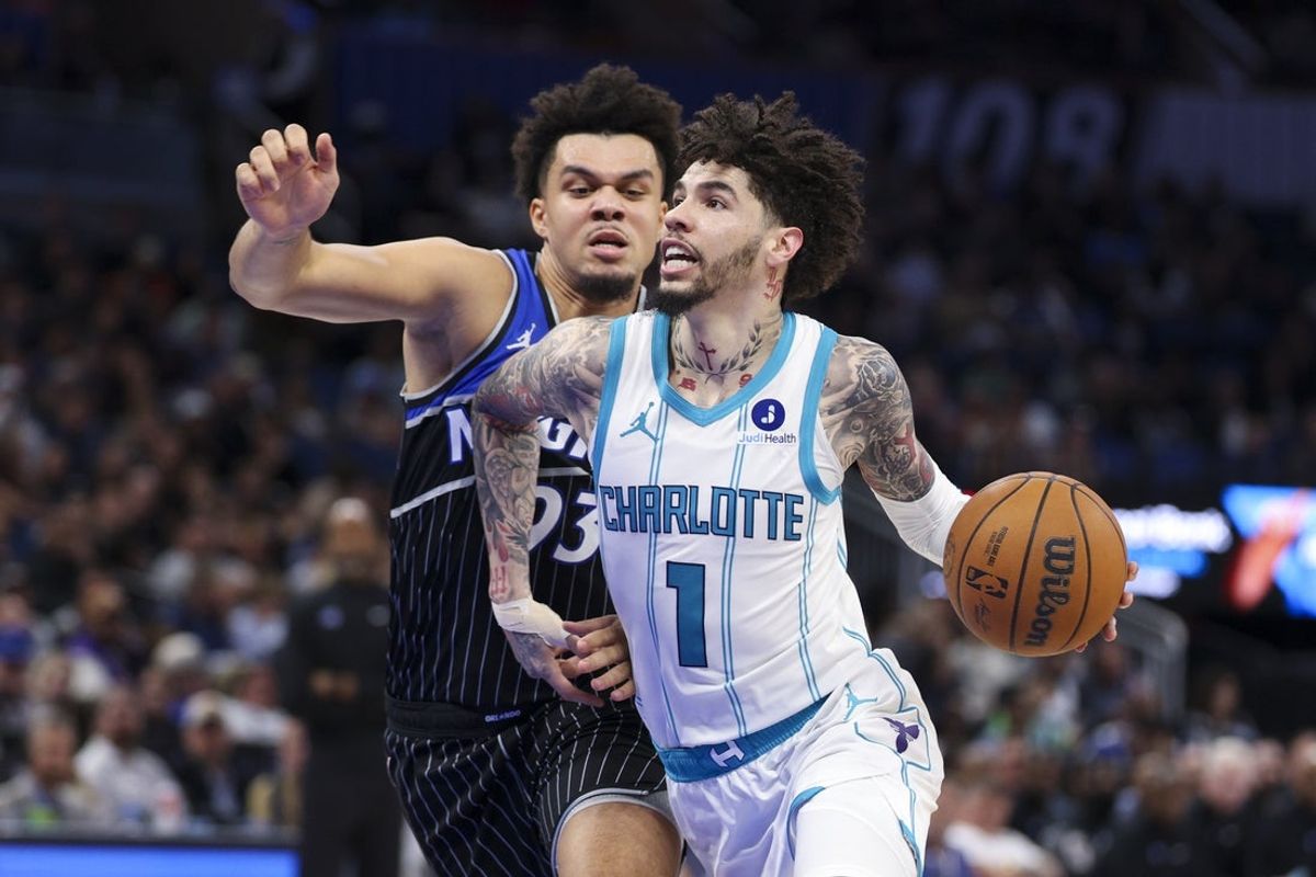 Jan 22, 2026; Orlando, Florida, USA; Charlotte Hornets guard LaMelo Ball (1) drives the ball past Orlando Magic forward Noah Penda (93) in the fourth quarter at Kia Center. Mandatory Credit: Nathan Ray Seebeck-Imagn Images