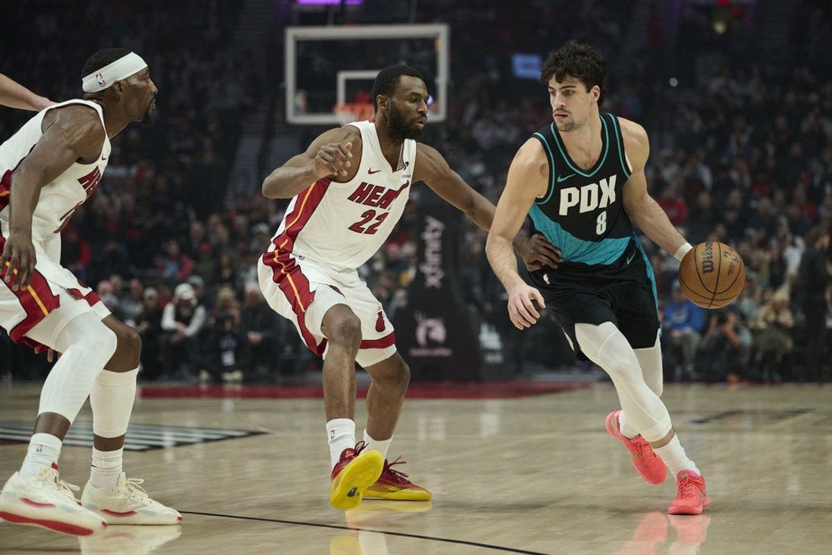 Jan 22, 2026; Portland, Oregon, USA; Portland Trail Blazers forward Deni Avdija (8) dribbles the ball during the first half against Miami Heat forward Andrew Wiggins (22) at Moda Center. Mandatory Credit: Troy Wayrynen-Imagn Images