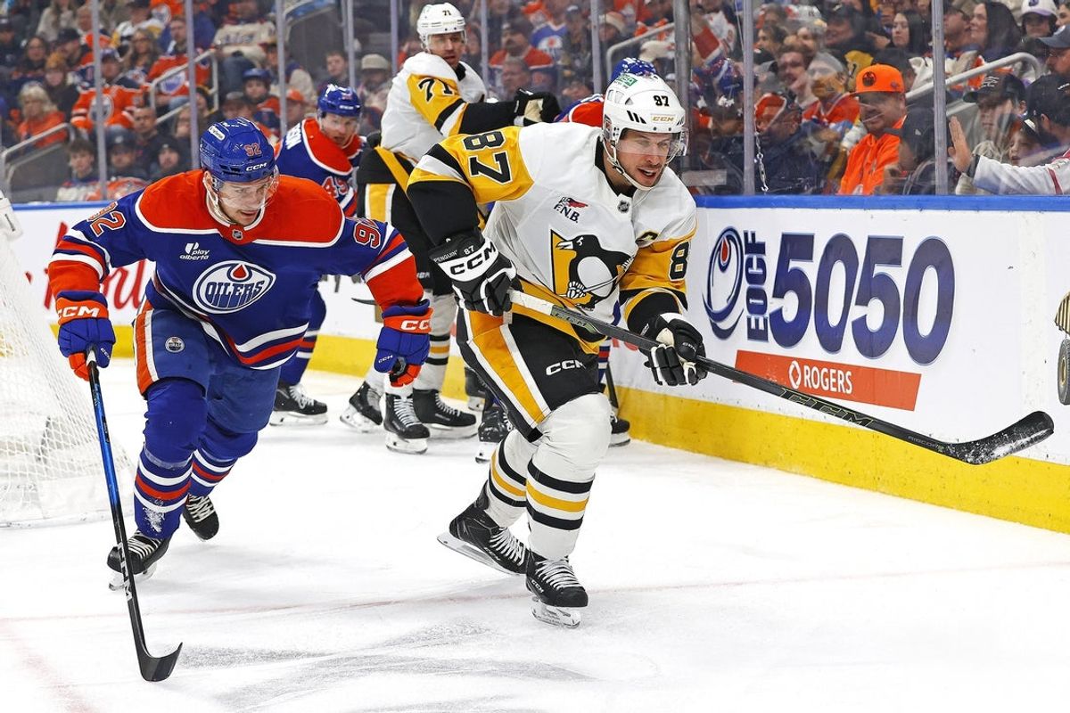 Jan 22, 2026; Edmonton, Alberta, CAN; Edmonton Oilers forward Vasily Podkolzin (92) and Pittsburgh Penguins forward Sidney Crosby (87) chase a loose puck during the second period at Rogers Place. Mandatory Credit: Perry Nelson-Imagn Images