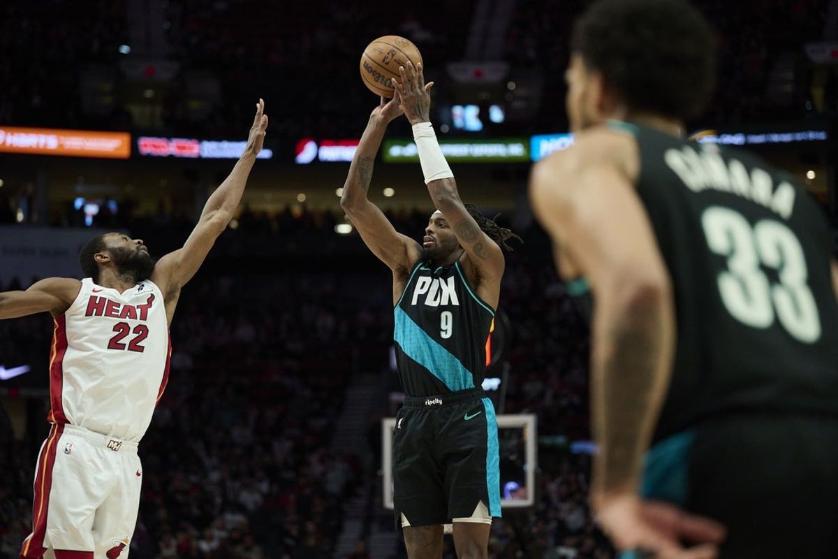 Jan 22, 2026; Portland, Oregon, USA; Portland Trail Blazers forward Jerami Grant (9) shoots a jump shot during the first half against Miami Heat forward Andrew Wiggins (22) at Moda Center. Mandatory Credit: Troy Wayrynen-Imagn Images