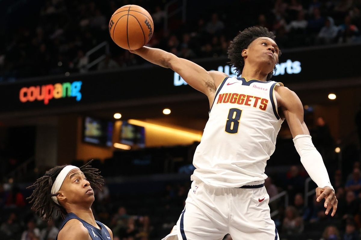 Jan 22, 2026; Washington, District of Columbia, USA; Denver Nuggets forward Peyton Watson (8) attempts a dunk over Washington Wizards guard Tre Johnson (12) during the second half at Capital One Arena. Mandatory Credit: Daniel Kucin Jr.-Imagn Images