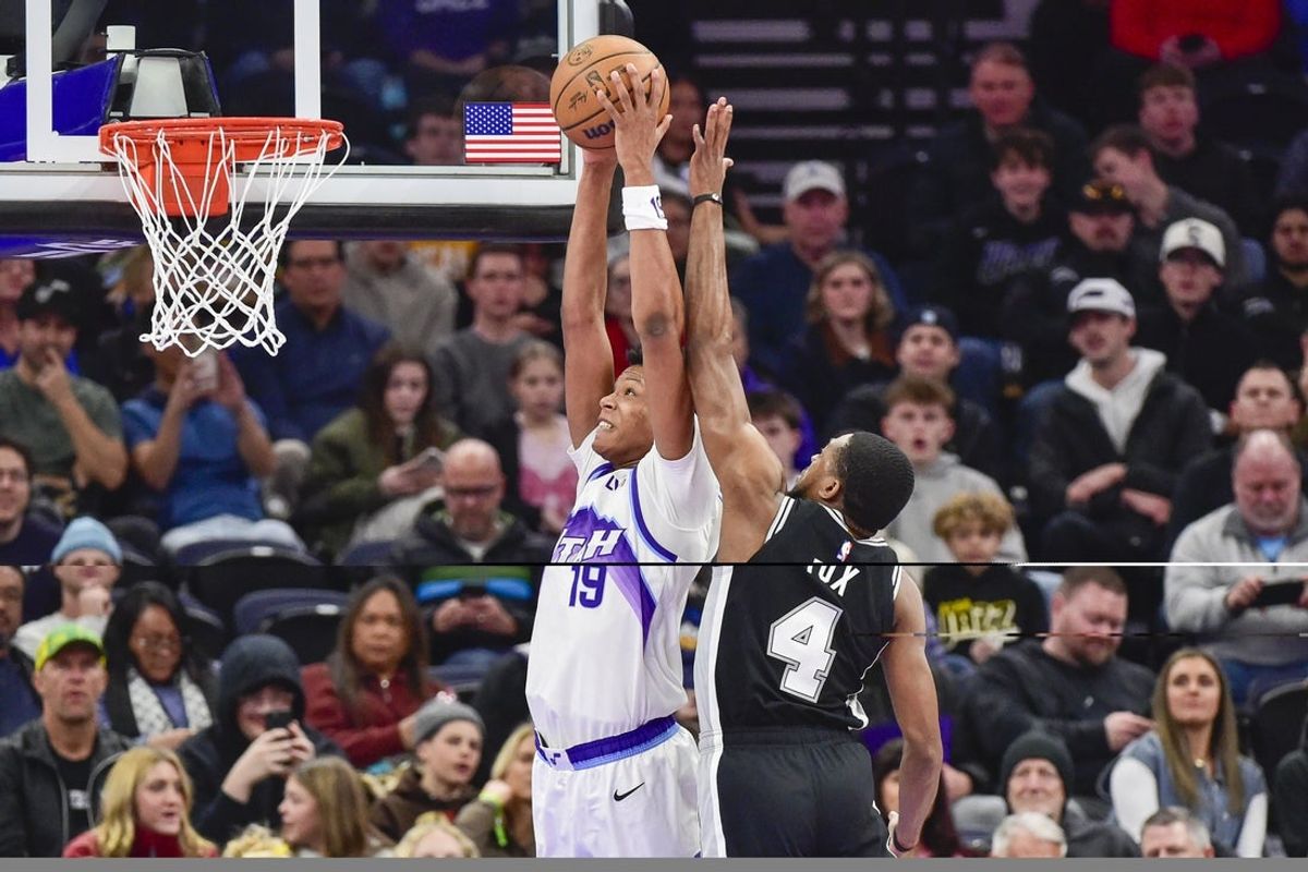 Jan 22, 2026; Salt Lake City, Utah, USA; Utah Jazz forward Ace Bailey (19) dunks around San Antonio Spurs guard De'Aaron Fox (4) during the first half at Delta Center. Mandatory Credit: Peter Creveling-Imagn Images