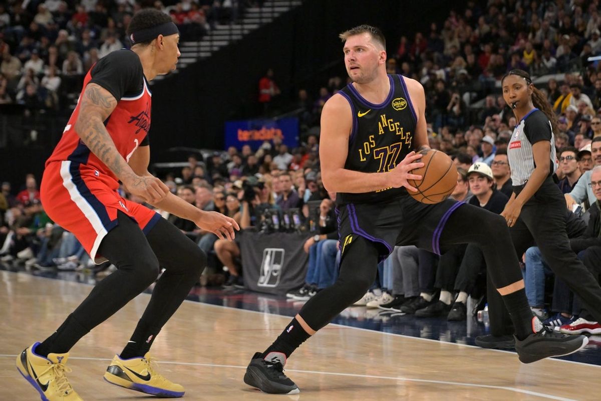 Jan 22, 2026; Inglewood, California, USA;  Los Angeles Lakers guard Luka Doncic (77) is defended by Los Angeles Clippers guard Jordan Miller (22) in the second half at Intuit Dome. Mandatory Credit: Jayne Kamin-Oncea-Imagn Images