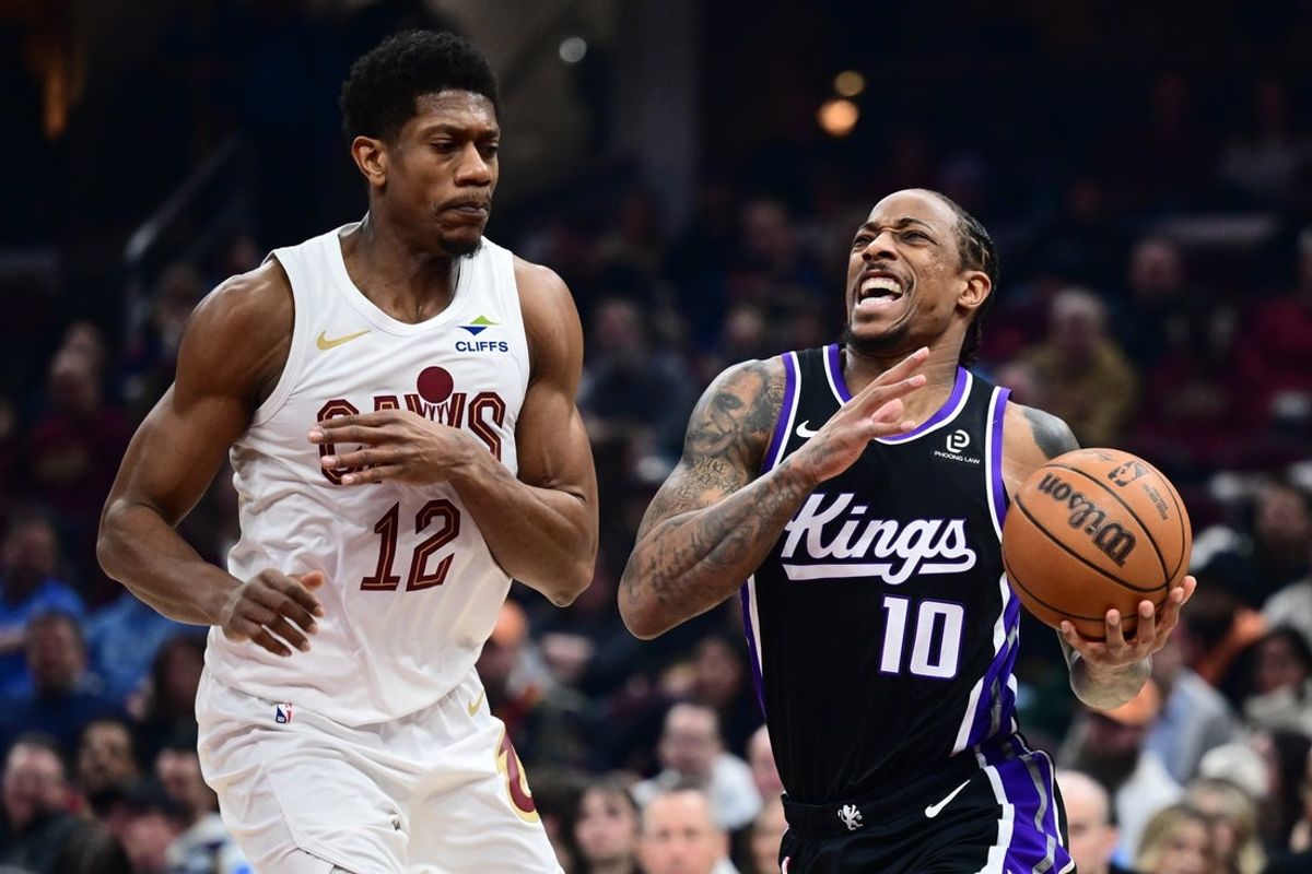 Jan 23, 2026; Cleveland, Ohio, USA; Sacramento Kings guard DeMar DeRozan (10) drives to the basket against Cleveland Cavaliers forward De'andre Hunter (12) during the first half at Rocket Arena. Mandatory Credit: Ken Blaze-Imagn Images