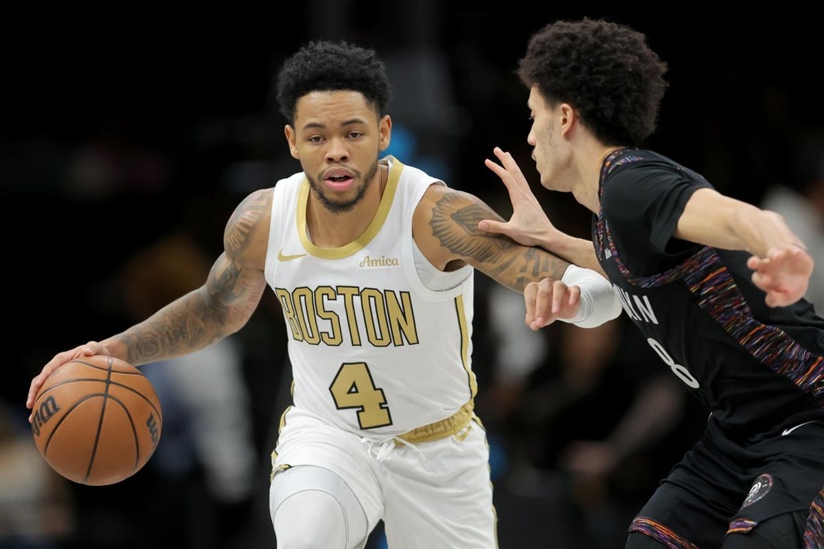 Jan 23, 2026; Brooklyn, New York, USA; Boston Celtics guard Anfernee Simons (4) brings the ball up court against Brooklyn Nets guard Nolan Traore (88) during the first quarter at Barclays Center. Mandatory Credit: Brad Penner-Imagn Images