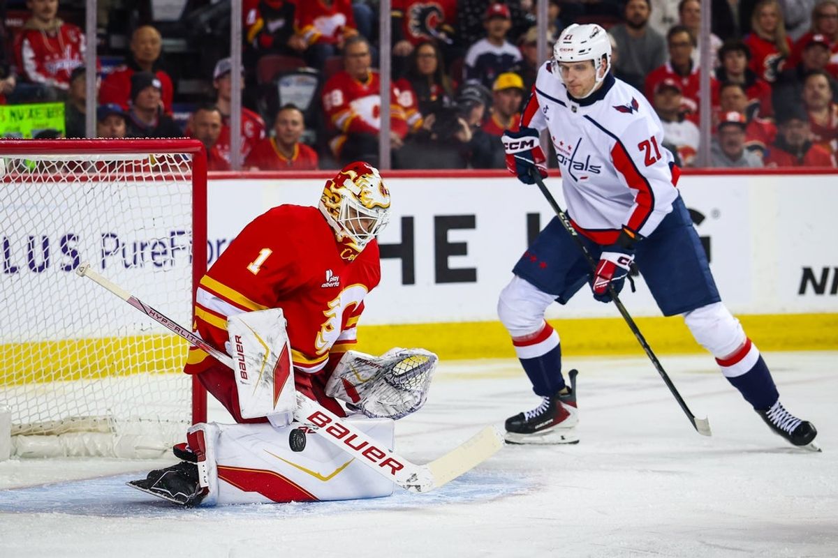 Jan 23, 2026; Calgary, Alberta, CAN; Calgary Flames goaltender Devin Cooley (1) makes a save against the Washington Capitals during the first period at Scotiabank Saddledome. Mandatory Credit: Sergei Belski-Imagn Images