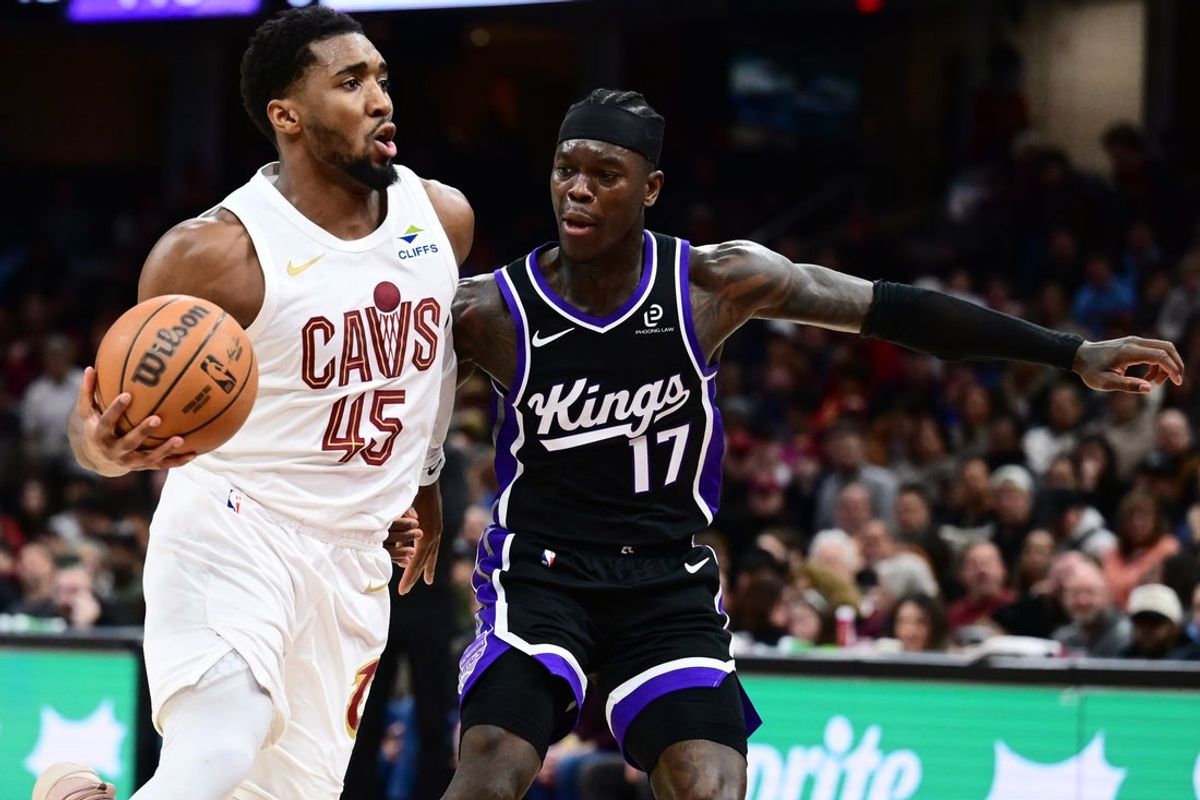 Jan 23, 2026; Cleveland, Ohio, USA; Cleveland Cavaliers guard Donovan Mitchell (45) drives to the basket against Sacramento Kings guard Dennis Schroder (17) during the second half at Rocket Arena. Mandatory Credit: Ken Blaze-Imagn Images