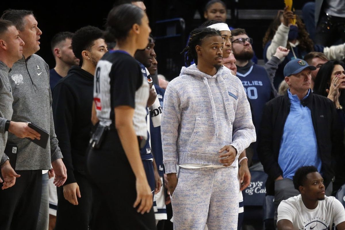 Jan 23, 2026; Memphis, Tennessee, USA; Memphis Grizzlies guard Ja Morant (12) looks on from the bench area during the fourth quarter against the New Orleans Pelicans at FedExForum. Mandatory Credit: Petre Thomas-Imagn Images