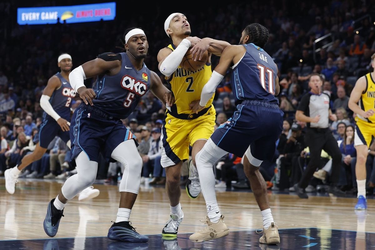 Jan 23, 2026; Oklahoma City, Oklahoma, USA; Indiana Pacers guard/forward Andrew Nembhard (2) drives between Oklahoma City Thunder guard Luguentz Dort (5) and guard Isaiah Joe (11) during the second half at Paycom Center. Mandatory Credit: Alonzo Adams-Imagn Images