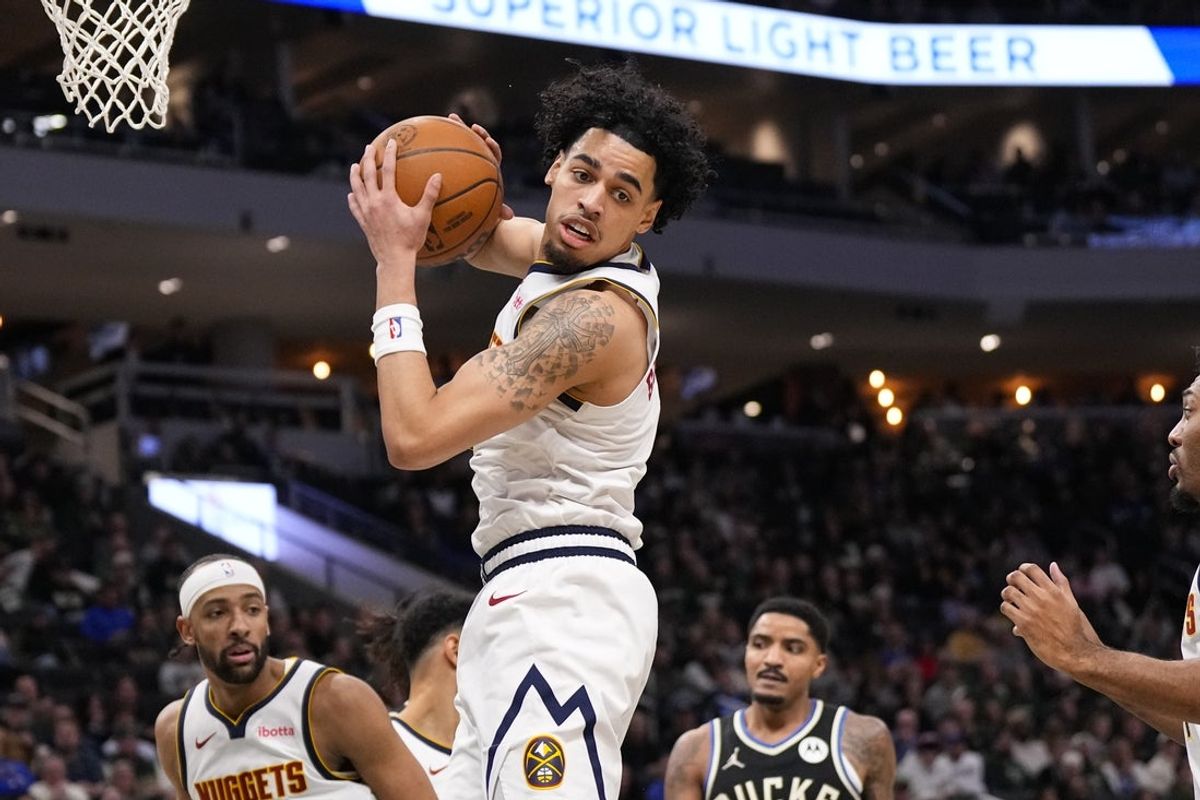 Jan 23, 2026; Milwaukee, Wisconsin, USA;  Denver Nuggets forward Julian Strawther (3) grabs a rebound during the second quarter against the Milwaukee Bucks at Fiserv Forum. Mandatory Credit: Jeff Hanisch-Imagn Images