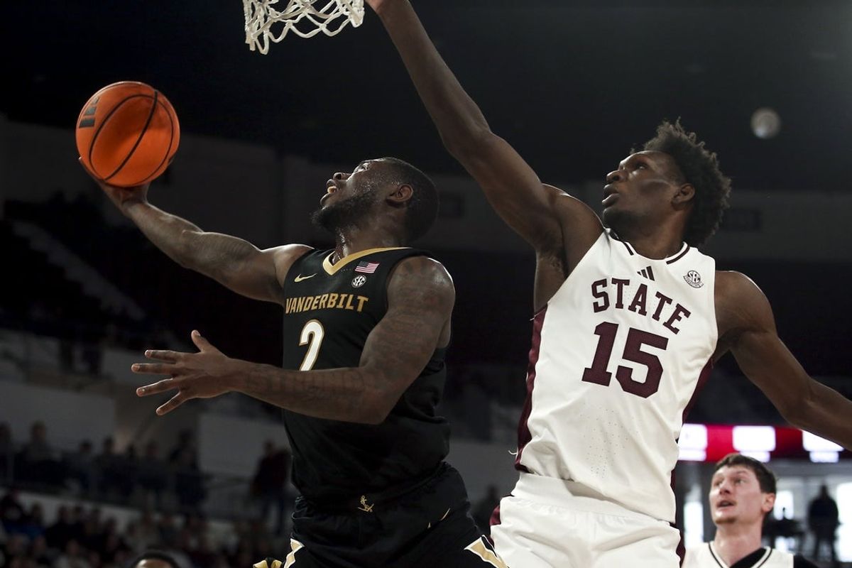 Jan 24, 2026; Starkville, Mississippi, USA; Vanderbilt Commodores guard Duke Miles (2) drives to the basket as Mississippi State Bulldogs center Quincy Ballard (15) defends during the first half at Humphrey Coliseum. Mandatory Credit: Petre Thomas-Imagn Images