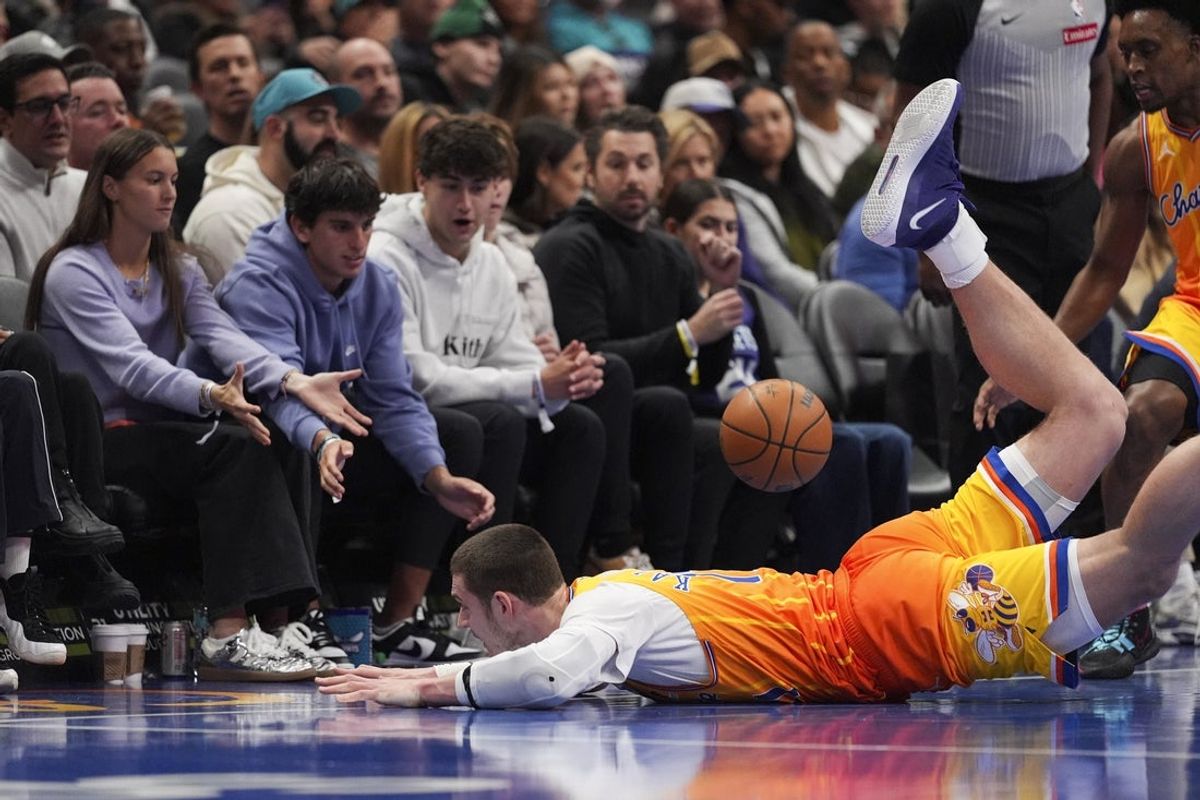 Jan 24, 2026; Charlotte, North Carolina, USA; Charlotte Hornets center Ryan Kalkbrenner (11) dives for the ball against the Washington Wizards during the second quarter at the Spectrum Center. Mandatory Credit: Jim Dedmon-Imagn Images