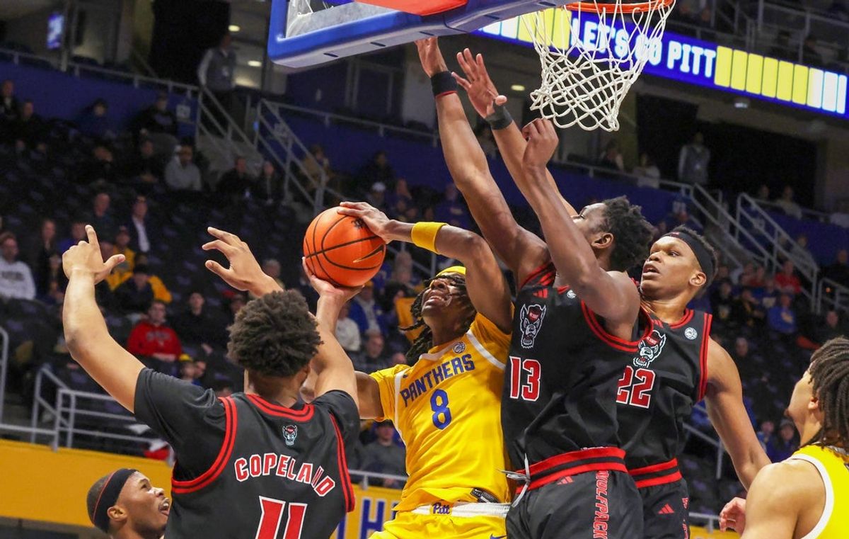 Jan 24, 2026; Pittsburgh, Pennsylvania, USA;  Pittsburgh Panthers guard Omari Witherspoon (8) shoots as NC State Wolfpack guard Quadir Copeland (11) and forwards Musa Sagnia (13) and Ven-Allen Lubin (22) defend during the first half at the Petersen Events Center. Mandatory Credit: Charles LeClaire-Imagn Images
