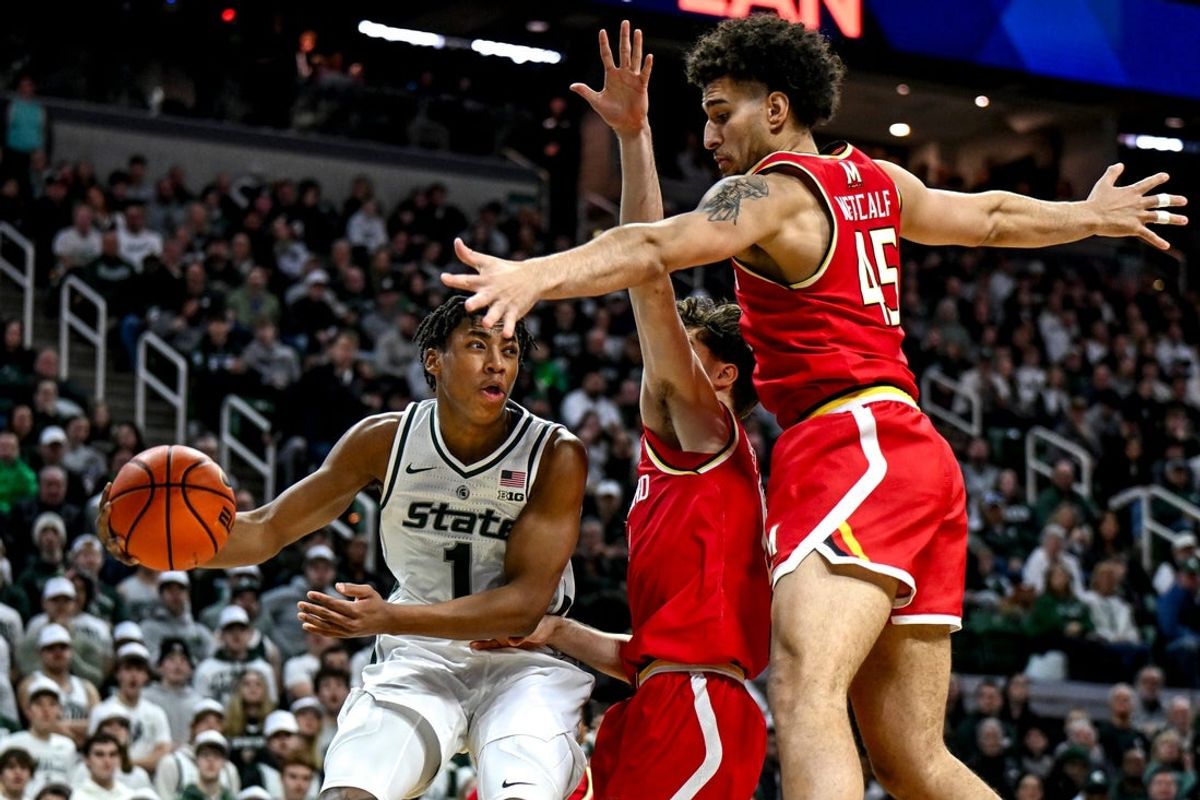 Michigan State's Jeremy Fears Jr., left, passes around Maryland's defense for an assist on a 3-pointer during the first half on Saturday, Jan. 24, 2026, at the Breslin Center in East Lansing.