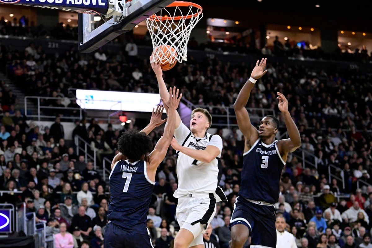 Jan 24, 2026; Providence, Rhode Island, USA; Providence Friars guard Stefan Vaaks (7) shoots a lay up against Georgetown Hoyas forward Isaiah Abraham (7) during the first half at Amica Mutual Pavilion. Mandatory Credit: Eric Canha-Imagn Images