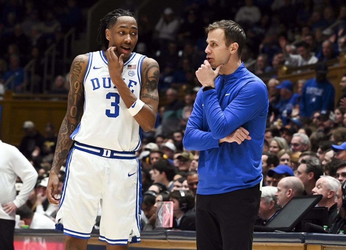 Jan 24, 2026; Durham, North Carolina, USA; Duke Blue Devils head coach Jon Scheyer (right) talks to forward Isaiah Evans (3) during the second half against the Wake Forest Demon Deacons at Cameron Indoor Stadium. Mandatory Credit: Rob Kinnan-Imagn Images